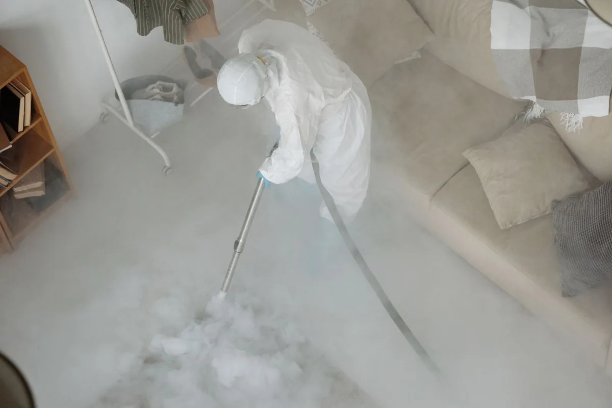 Biohazard cleanup technician in protective equipment, Brockton, MA